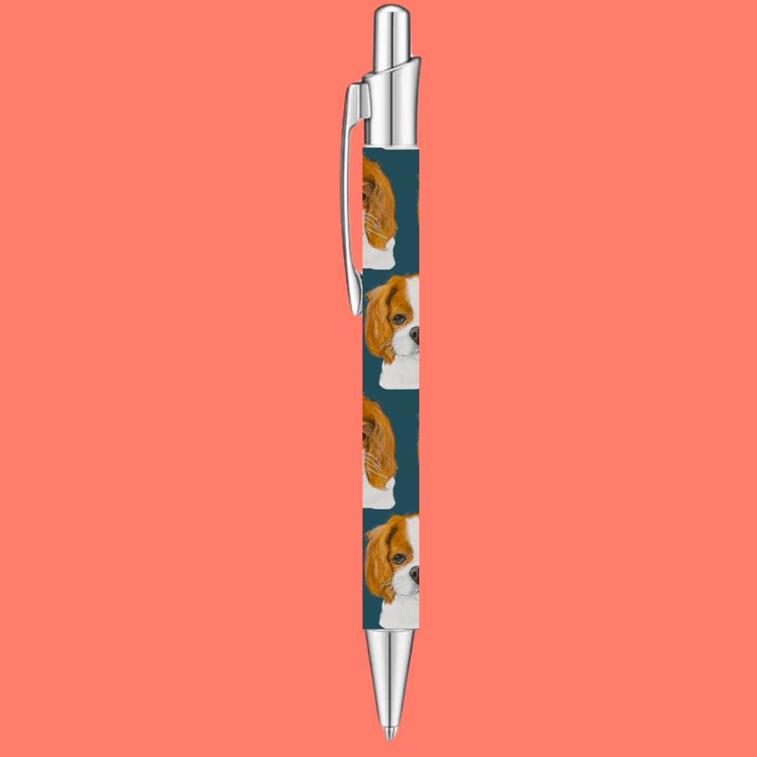 Click pen with repeating Cavalier King Charles Spaniel print on a teal barrel and silver clip