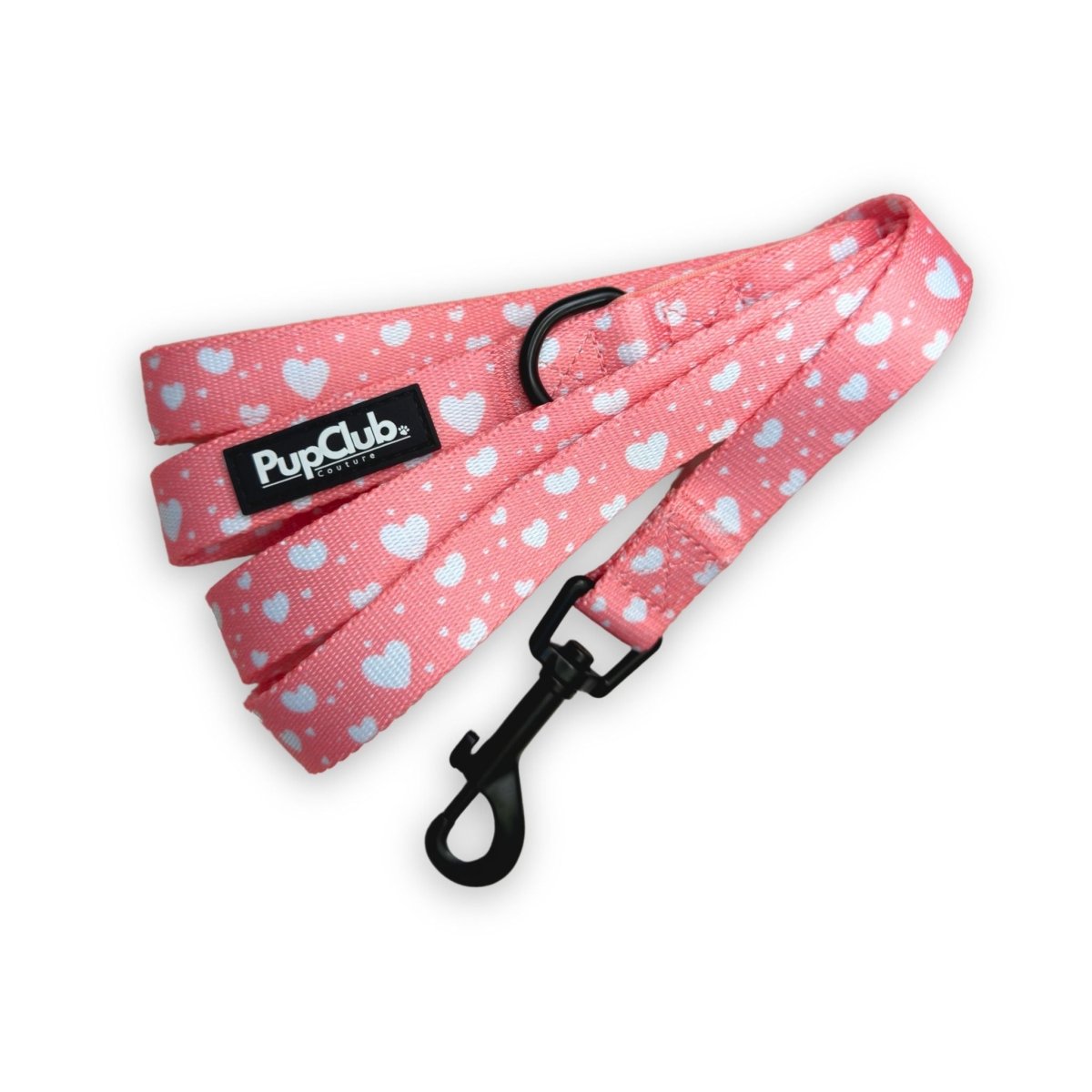 Peachy Hearts Dog Lead in coral pink with white hearts, black swivel clip and PupClub label