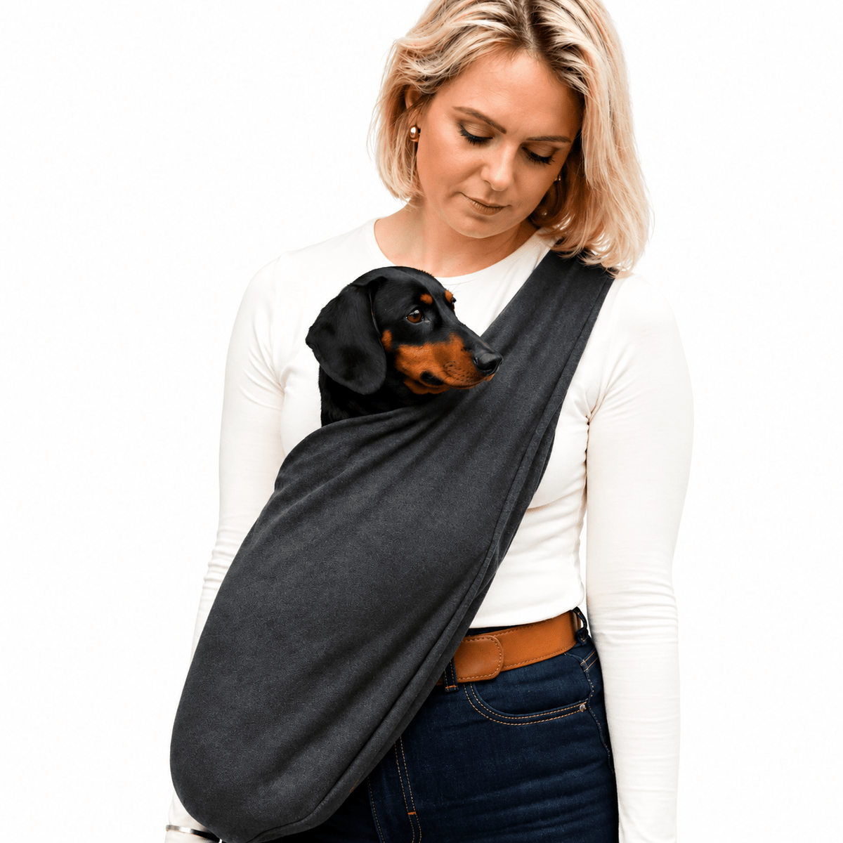 Woman wearing a charcoal Lite Sweatshirt Dog Sling with a black and tan dachshund