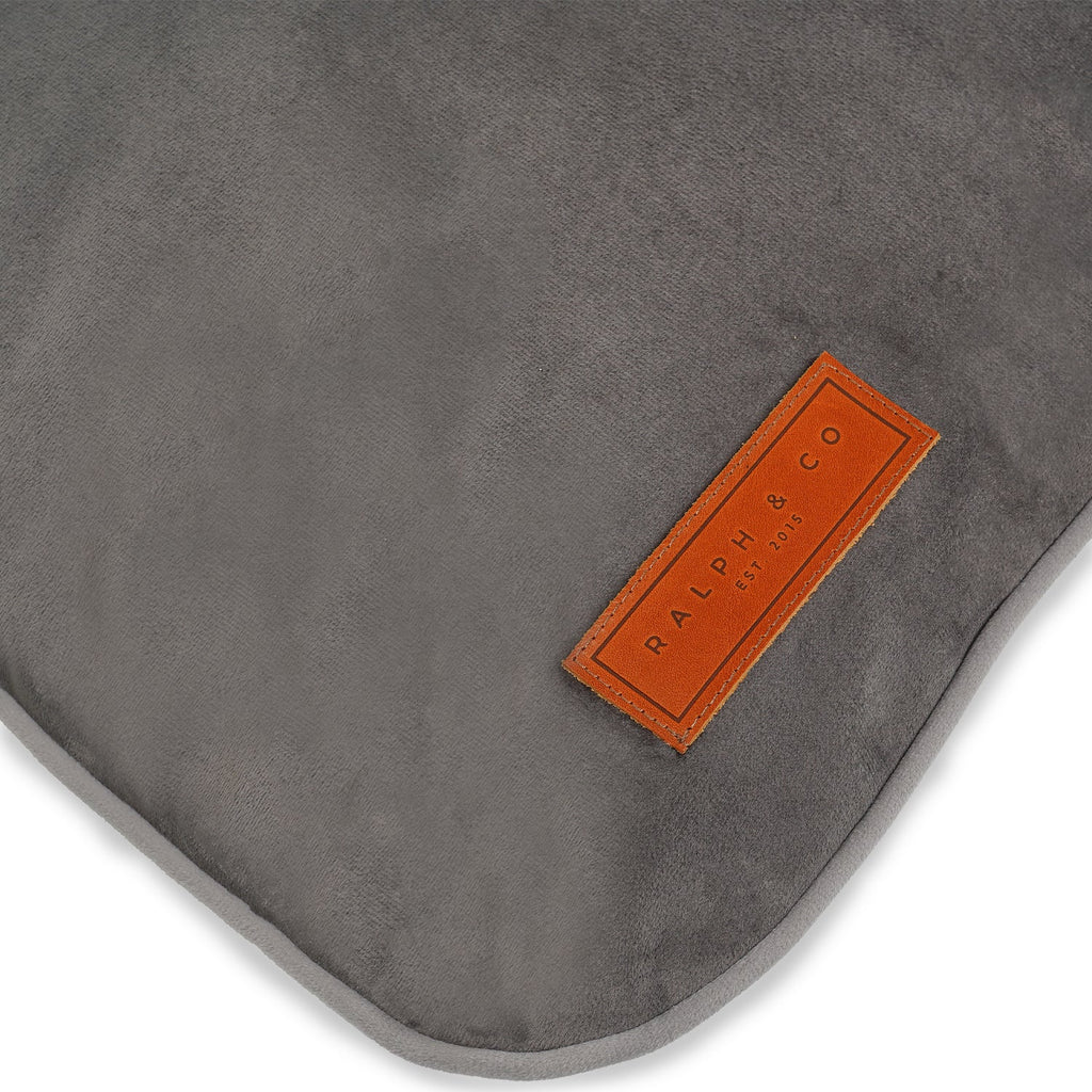 Close-up of the leather Ralph & Co badge on the grey crate mattress