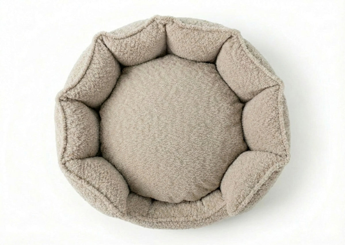 Top-down view of the round Cotswold high wall bouclé dog bed