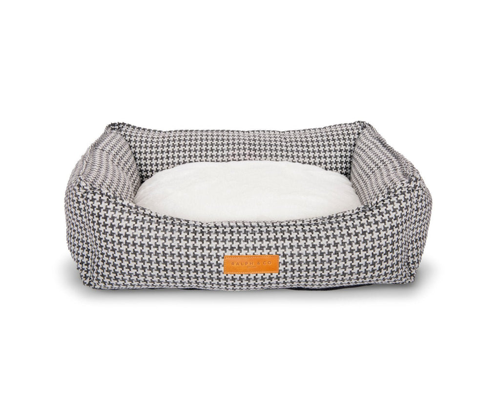 Kensington houndstooth bolster bed with the cream faux fur side of the cushion facing up