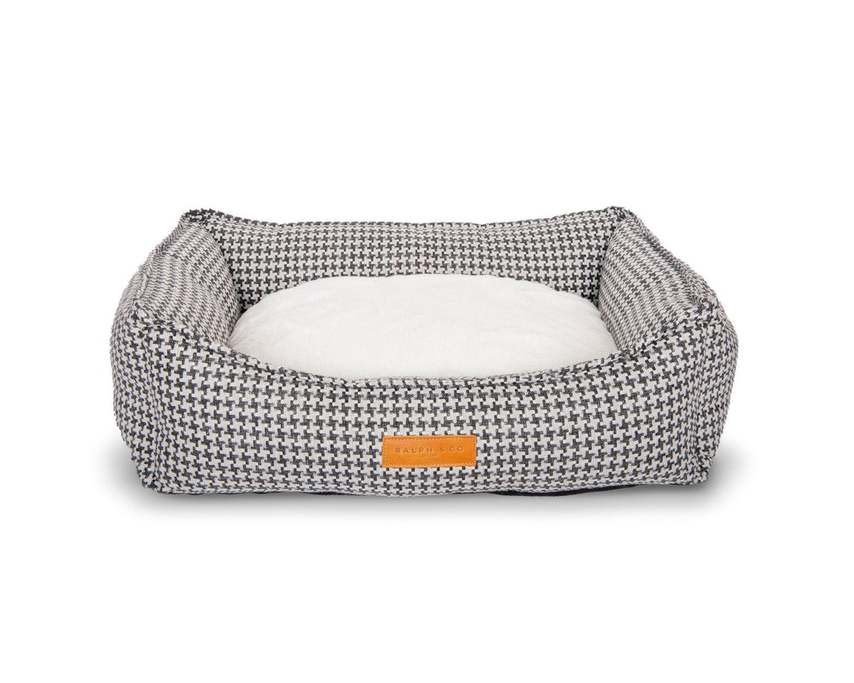 Kensington houndstooth bolster bed with the cream faux fur side of the cushion facing up