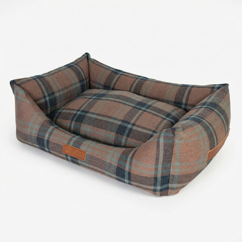 Marlow tartan bolster dog bed shown at an angle