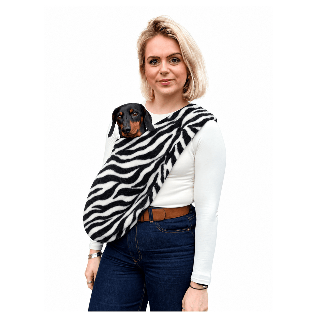 Woman wearing a zebra print Patterned Fleece Dog Sling with a black and tan dachshund
