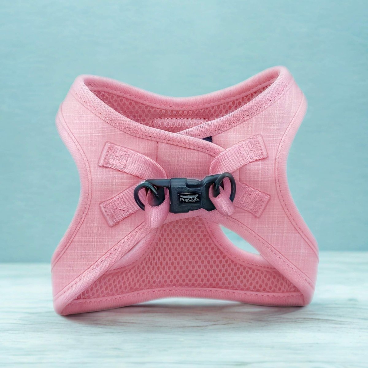Back of the pink Puppy Step-In Harness showing velcro straps and clip buckle