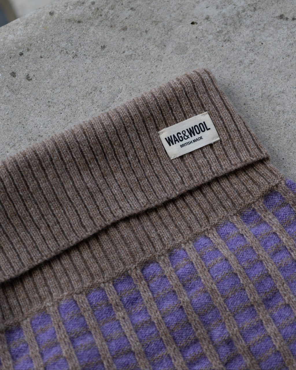 Close-up of the taupe ribbed roll neck on the purple merino jumper
