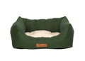 Richmond deep green bolster dog bed with cream sherpa cushion and leather badge