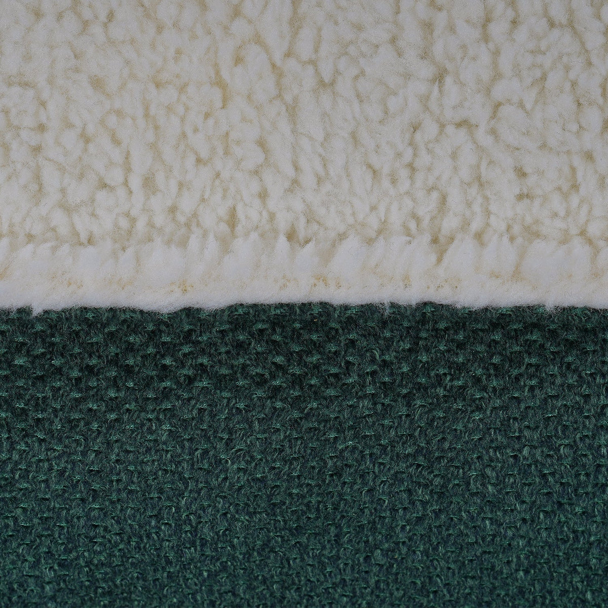 Close-up of the cream sherpa top and green woven fabric on the Richmond bed